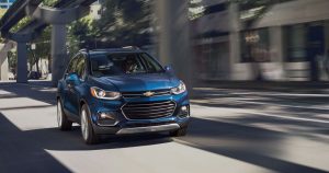 A blue 2019 Chevrolet Trax driving on the streets of Wichita, KS