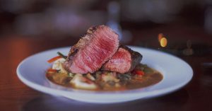 A steak dinner served over pasta at a local steakhouse in Wichita, KS