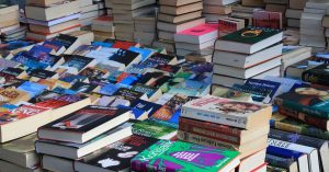 A large collection of books for sale on a table at a local bookstore in Wichita, KS